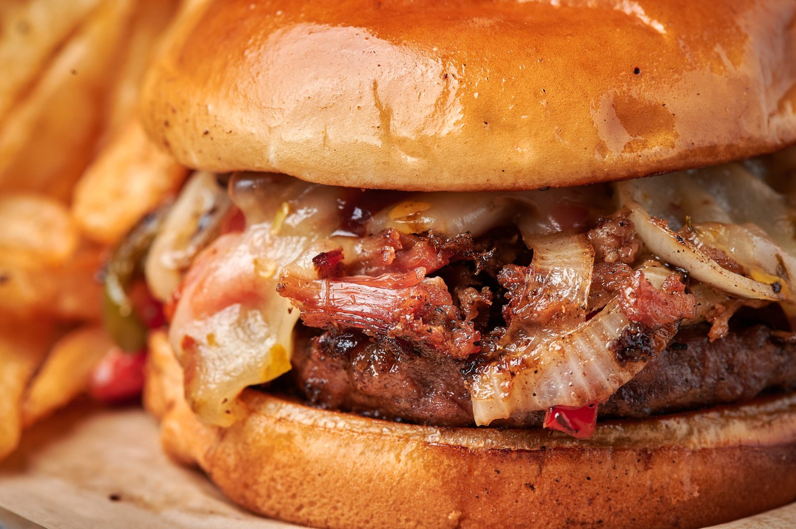 Brisket burger with melted cheese and grilled onions photographed for restaurant menu in Dallas